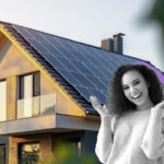 Jubelnde Frau steht vor einem Haus mit Solaranlage